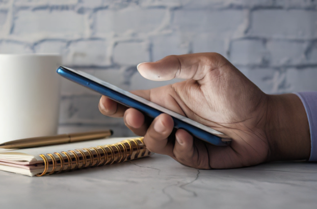 Phone beside a notebook representing difficult communication during divorce